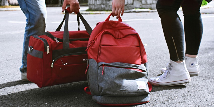 View of two bags held by tourists, ready to visit the largest artificial lake in India.