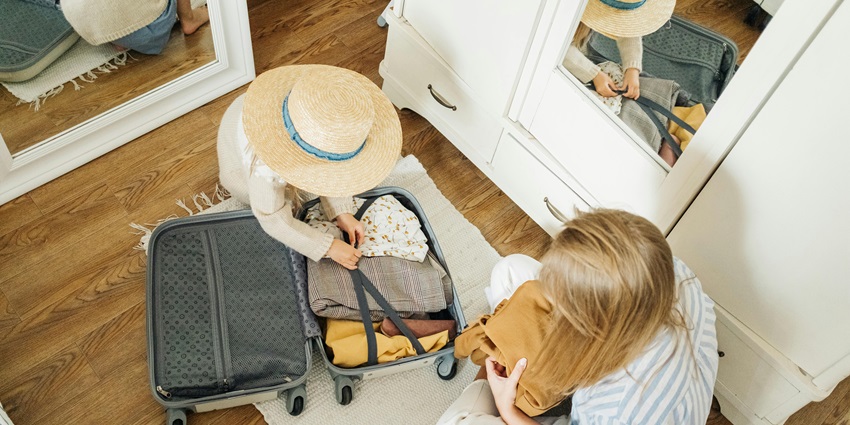 A Woman and a Child Packing a Suitcase - Carry suitable clothes when visiting Bruges city guide