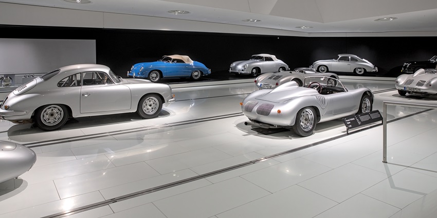 An image showing Porsche automobiles on display at the Porsche Museum, highlighting their design.