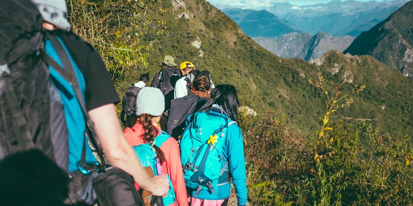 A group of adventurers hike through the hilly terrain of Rajdher Fort, Maharashtra