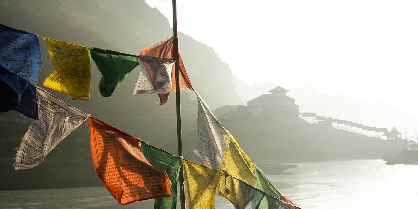 Image of colourful buddhist flags hanging near the Tsomgo Lake in Sikkim