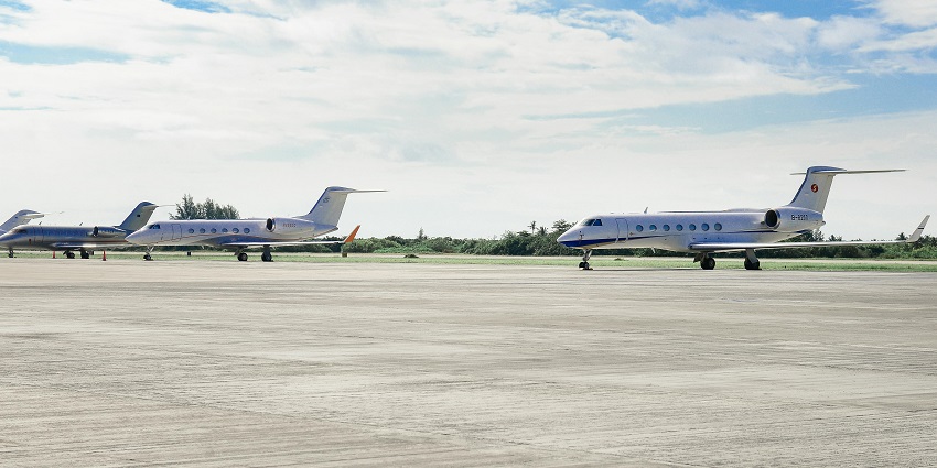 Three parked planes standing in Oudomsay Airport.