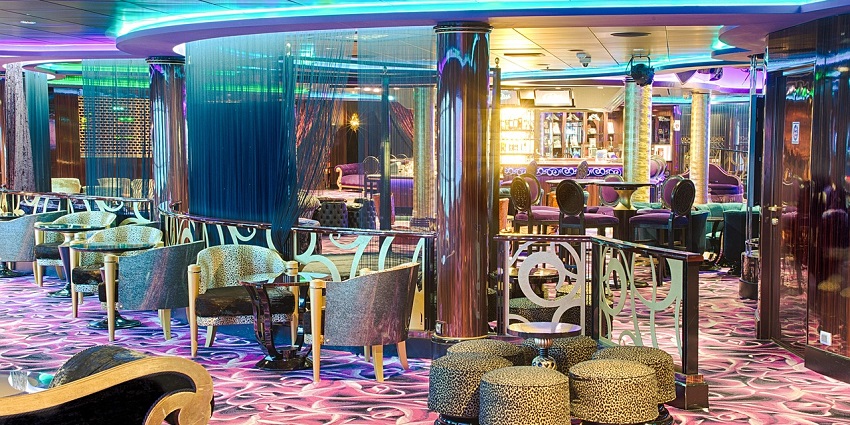 A lounge with colorful lighting and seating similar to lounges in Oulu Nightlife District