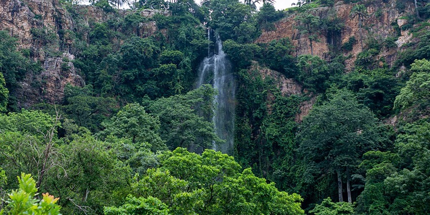 Nigeria waterfalls cascade dramatically from rocky cliffs into a refreshing natural pool.