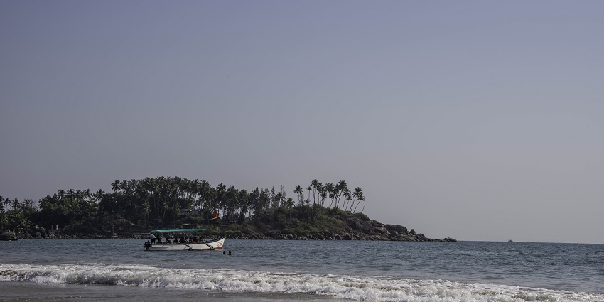 A tourist boat is anchored off Palolem Beach, one of the Bikini Beaches in India