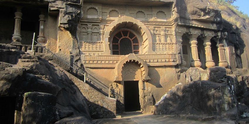 An image of the ancient rock-cut Pandavleni cave with intricate carvings and columns