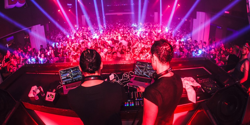 Vibrant DJ featuring pulsating music, lighting similar to Pandemonium Night Club