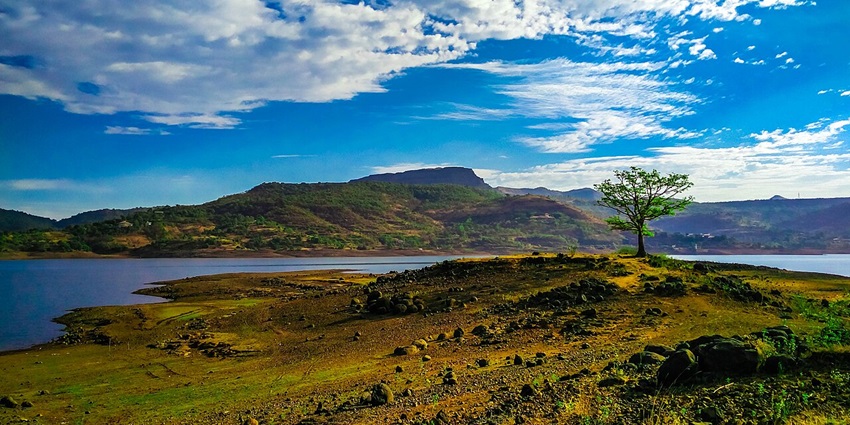 A misty morning setting of a cycling on scenic trail in a scenic getaway among the lakes in Pune