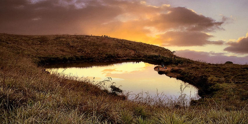 Sunset view of the Heart shaped Lake in Kerala with its colours reflecting in the water