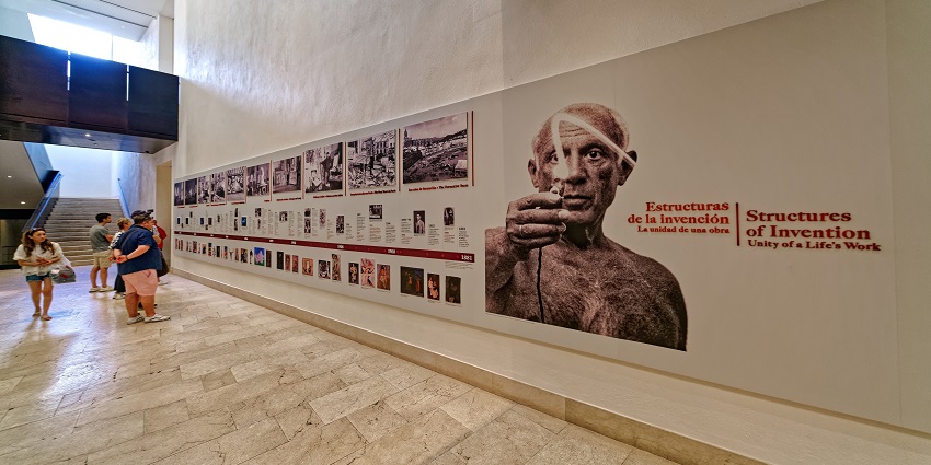 Visitors look at exhibitions hung on the walls of the Picasso Museum in Barcelona.