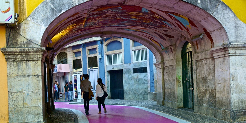 Image of beautiful Lanes of Pink Street in Lisbon and people strolling around