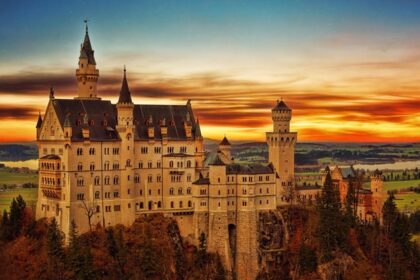 An image of a majestic castle with towers at sunset in Schwangau, Germany.