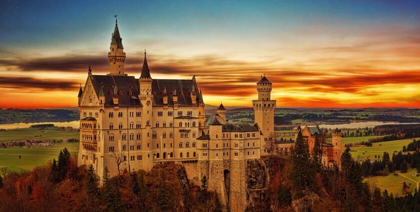 An image of a majestic castle with towers at sunset in Schwangau, Germany.