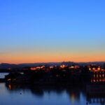 A romantic sunset view of Udaipur's Lake Pichola, reflecting December's peaceful and magical charm.