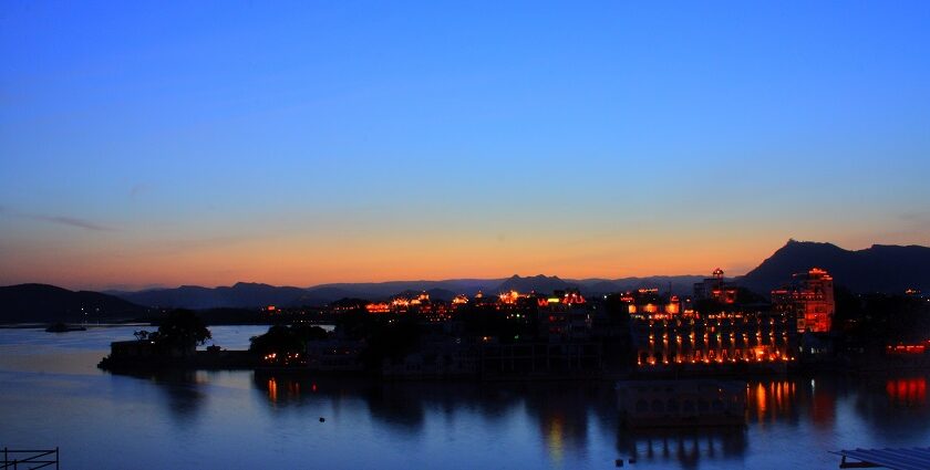 A romantic sunset view of Udaipur's Lake Pichola, reflecting December's peaceful and magical charm.