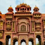 An image of a spectacular monument in Jaipur, one of the places to visit in January in north India, with clear blue skies and calm waves.