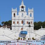 Statue of Virgin Mary in front and the bell tower on top. Panjim - A guide to diverse places to visit in Panjim at night