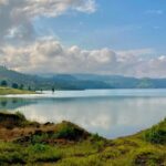 An image of Nashik’s beautiful landscape showcases vineyards and rolling hills.