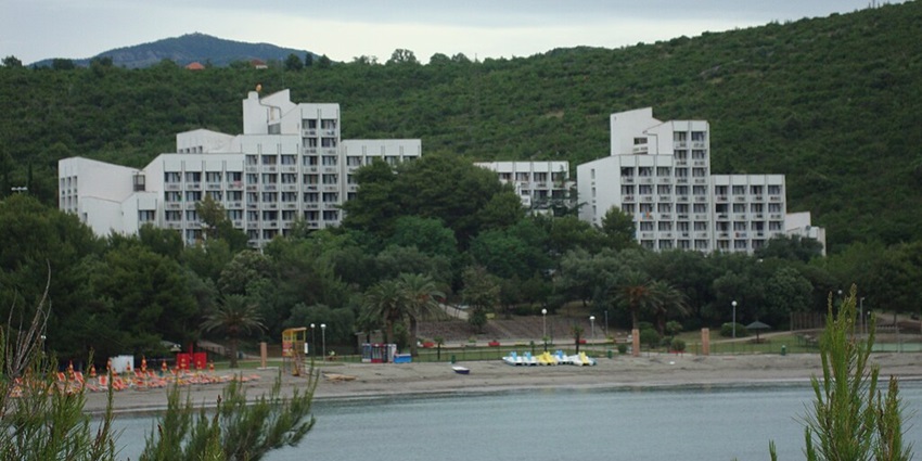 A sheltered beach with soft sand and calm waters, ideal for families in Tivat.