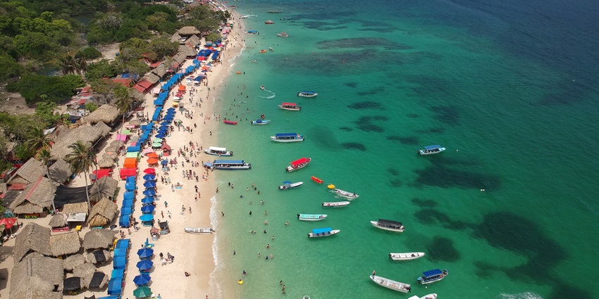 Pristine white sand beach with crystal-clear waters, perfect for relaxation and swimming.