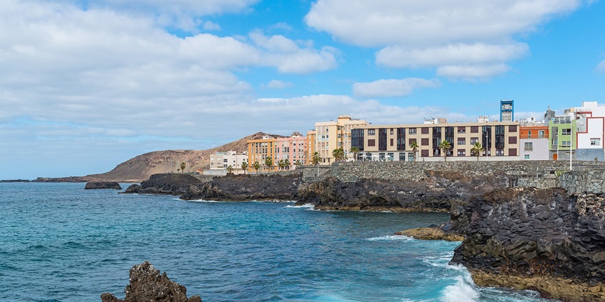 Image of Playa de las Canteras during day time and buildings near the near the beach