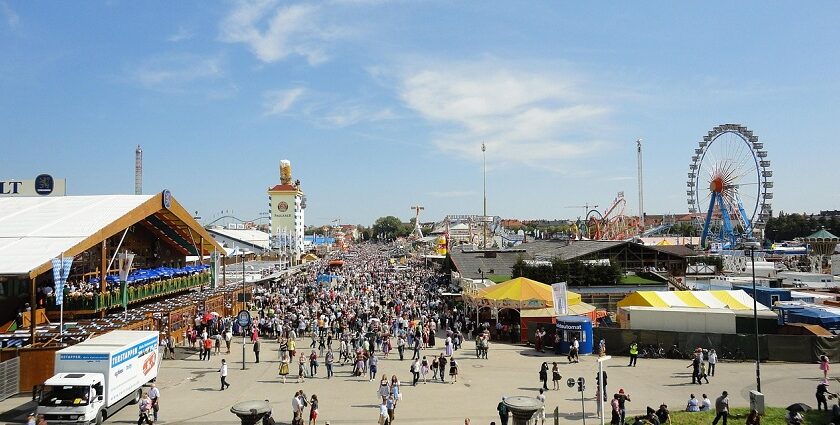 An image of people enjoying Oktoberfest in Munich, Germany, with festivities in the background.