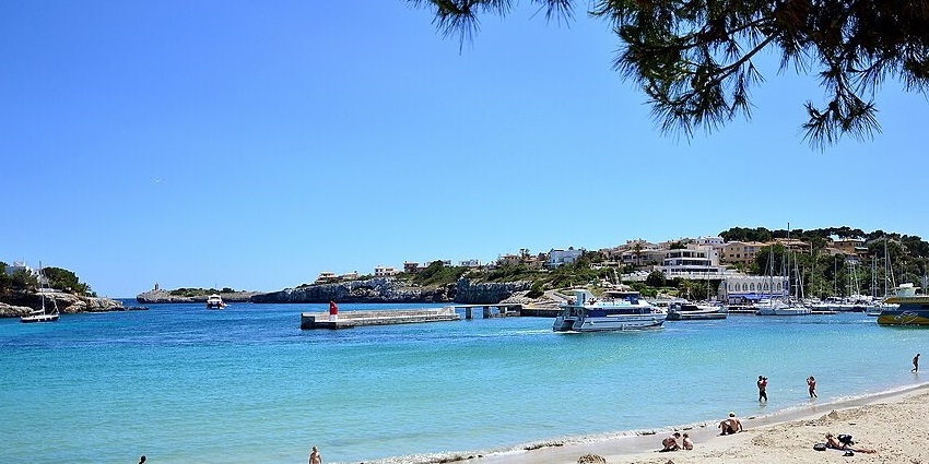 Relax by the crystal-clear waters of Porto Cristo Beach, a serene spot perfect for unwinding.