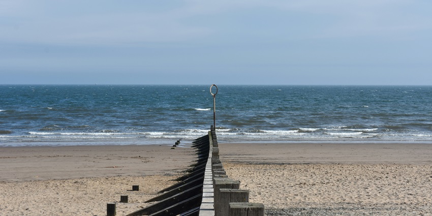 Tourists enjoying Portobello Beach, one of the famous beaches in Edinburgh, Scotland.