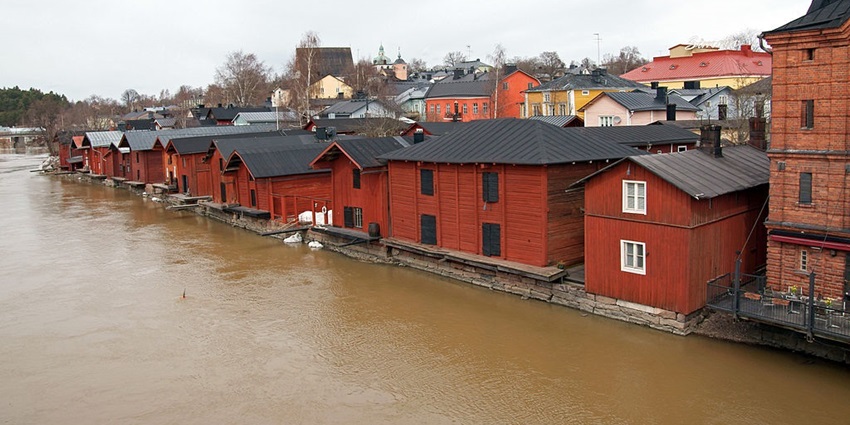 An image showing the charming riverside of Old Porvoo, with colorful buildings alongside.