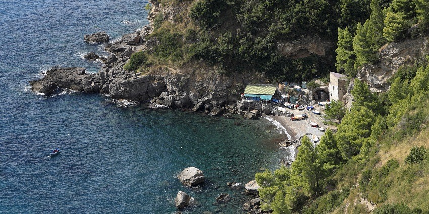 Rocks and dramatic cliffs at Positano Spiaggia Grande, a top beach in Positano, Italy