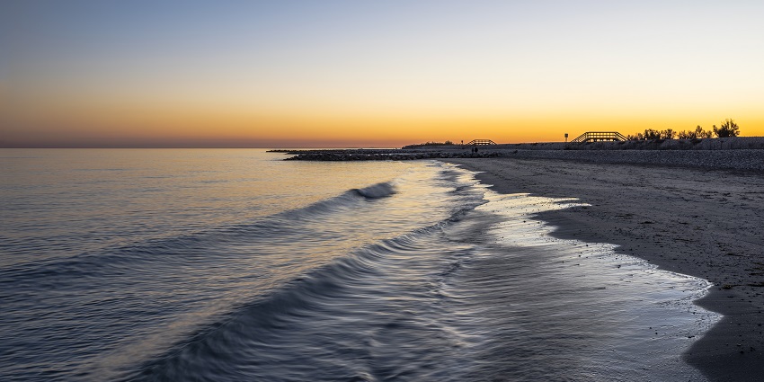 Mystical view of the golden sky at the beach in Lisbon .