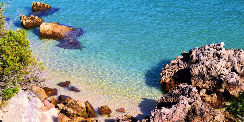 An image showing an aerial view of Praia dos Galapinhos beach, a scenic Portugal beach