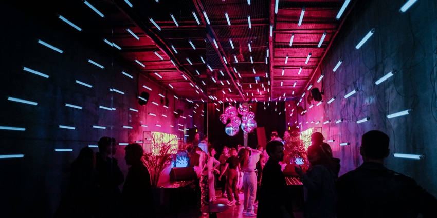 An image of DJ energizing the crowd at a club resembling the iconic Ibiza Spain nightlife