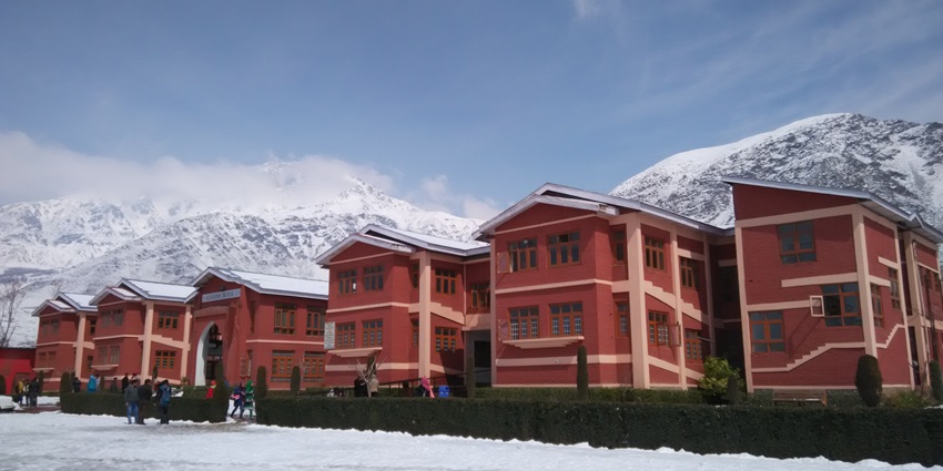 resh snowfall near a building in Pulwama, Kashmir.
