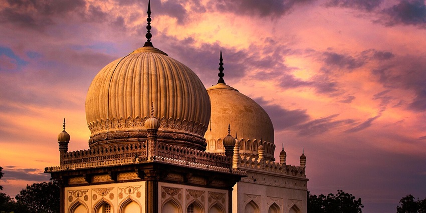 An image showing the Qutb Shahi Tombs, a historic site with domed structures and carvings.