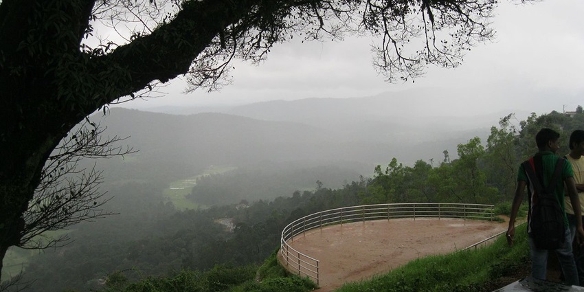 An image of Raja's Seat showcasing a beautiful view of the sunset over the hills in Coorg.