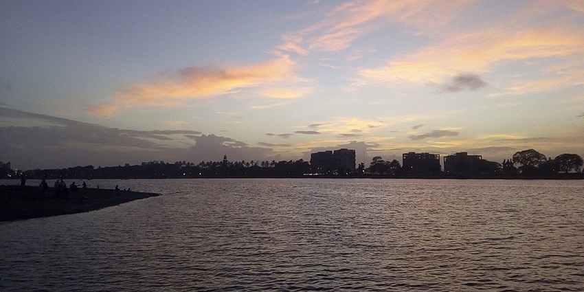 Rankala Lake in the evening with buildings in the background under a colourful cloudy sky