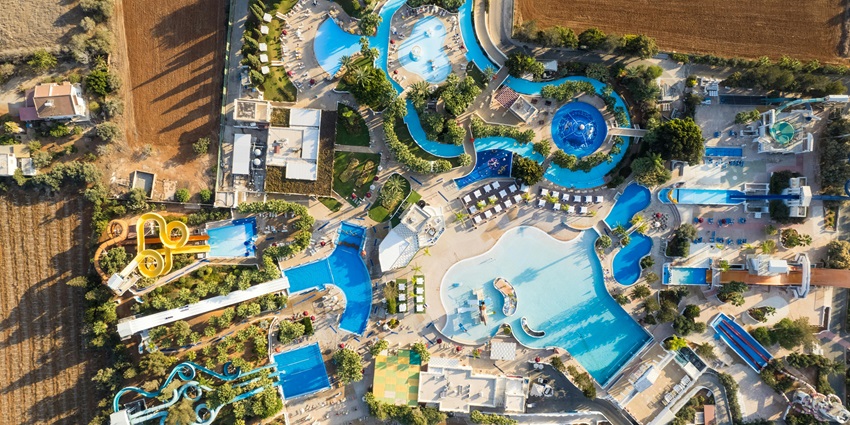 A picture of visitors relaxing by the poolside at the Drizzling Land Water Park.