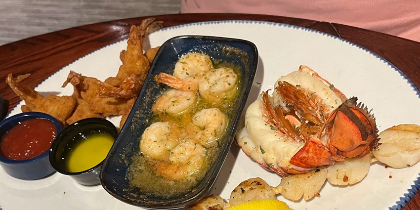 An image of a seafood platter of shellfish crabs and prawns cooked with Odia spices