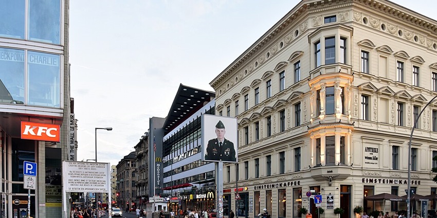 An image showing Checkpoint Charlie in Berlin, facing west, a historic Cold War site