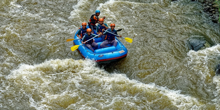 An image of a group of adventurers navigating a river rafting experience near Lonavala.