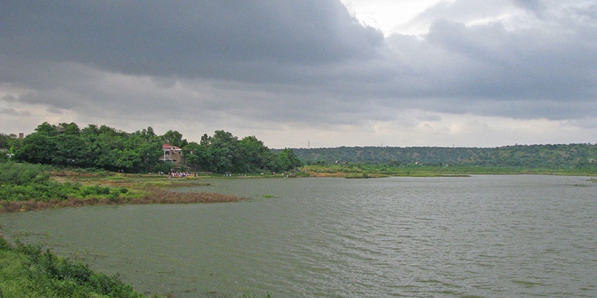 View of Damdama Lake, covered with lush greenery - one of the things to do at Damadama Lake.