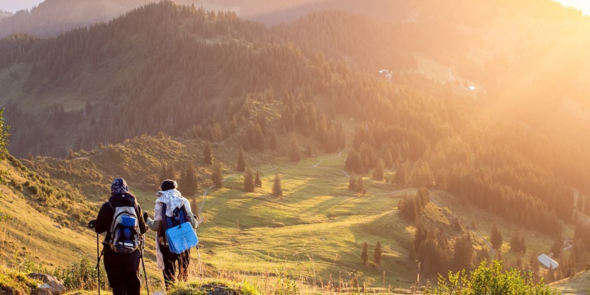 An image showing mountaineers trekking along a mountain trail, capturing the adventure