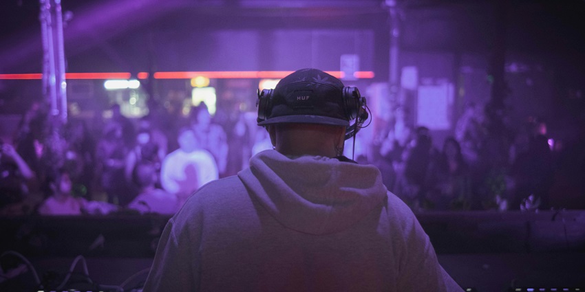 A DJ setting up electrifying vibes similar to Royal Club, resembling Riga nightlife