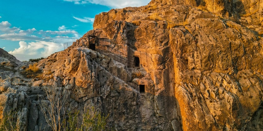 Scenic image of the caves in the stunning rocky cliff in the hills