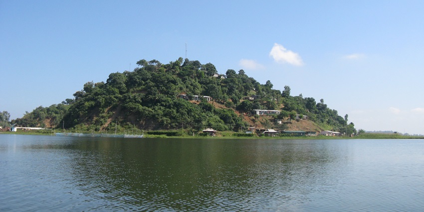 One of the lakes in Arunachal Pradesh with crystal clear water surrounded by a rocky mountain range and clear blue sky.