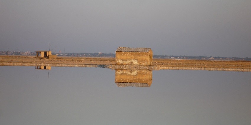 Sambhar Salt Lake with a perfect reflection of shorelines, sunset and distant mountains.