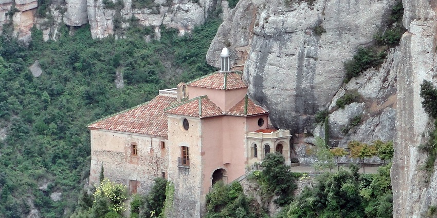 The chapel near the Monastery surrounded by lush greenery and huge rocks