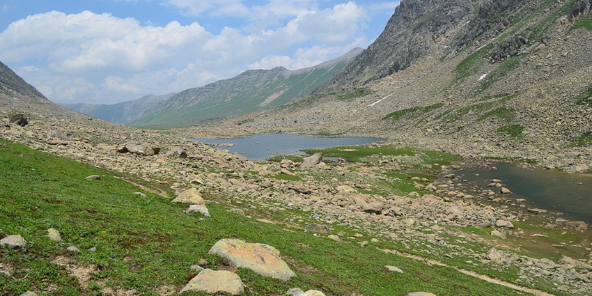 Satsar lakes with small lakes surrounded by rocky shores and mountains on both sides