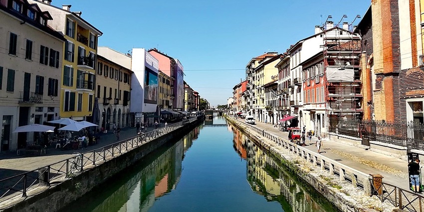 Watch the sunset at the Navigli District, where golden hues reflect on the canals